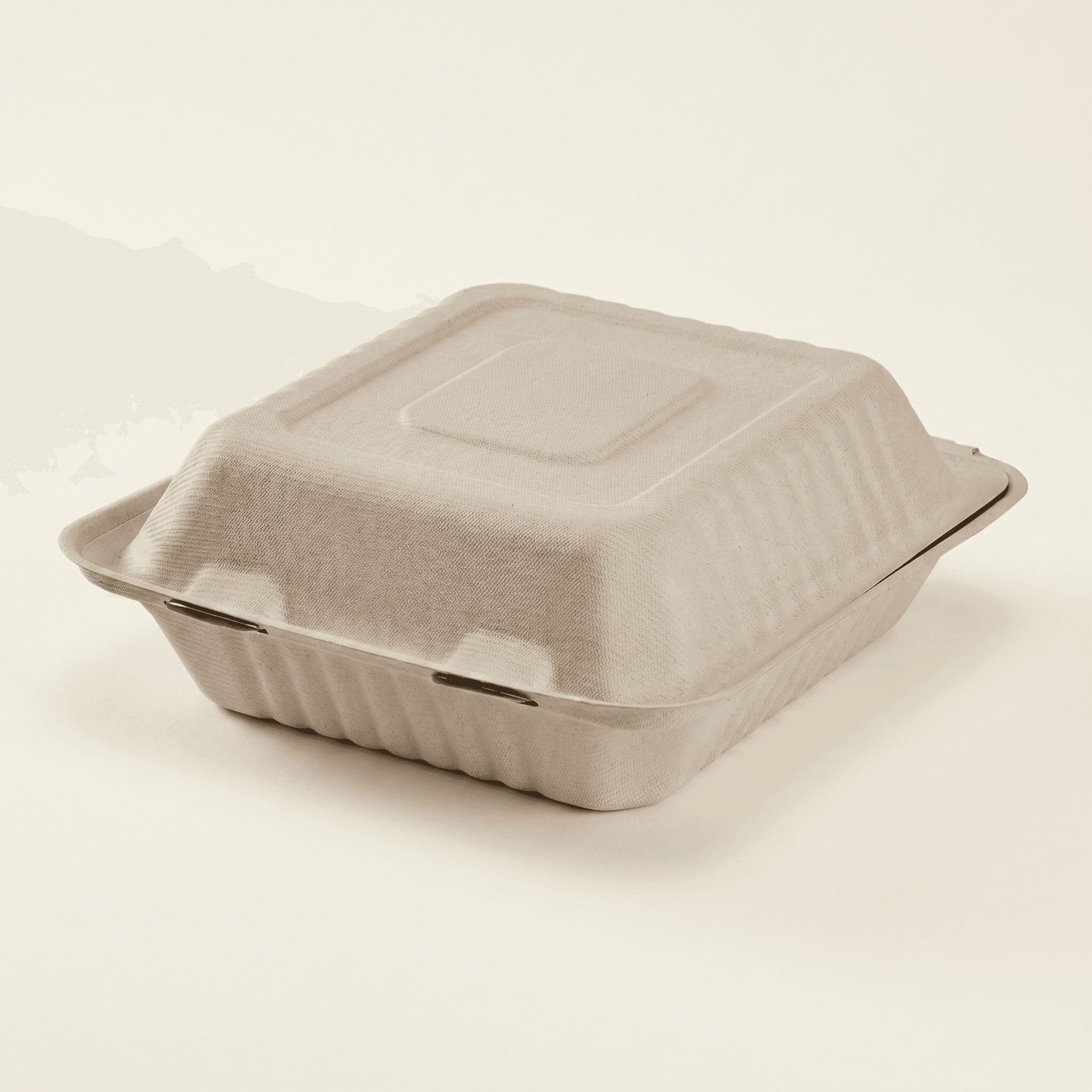 Closed 8×8 bagasse clamshell at a three-quarter angle, showing the hinge and latching front tabs