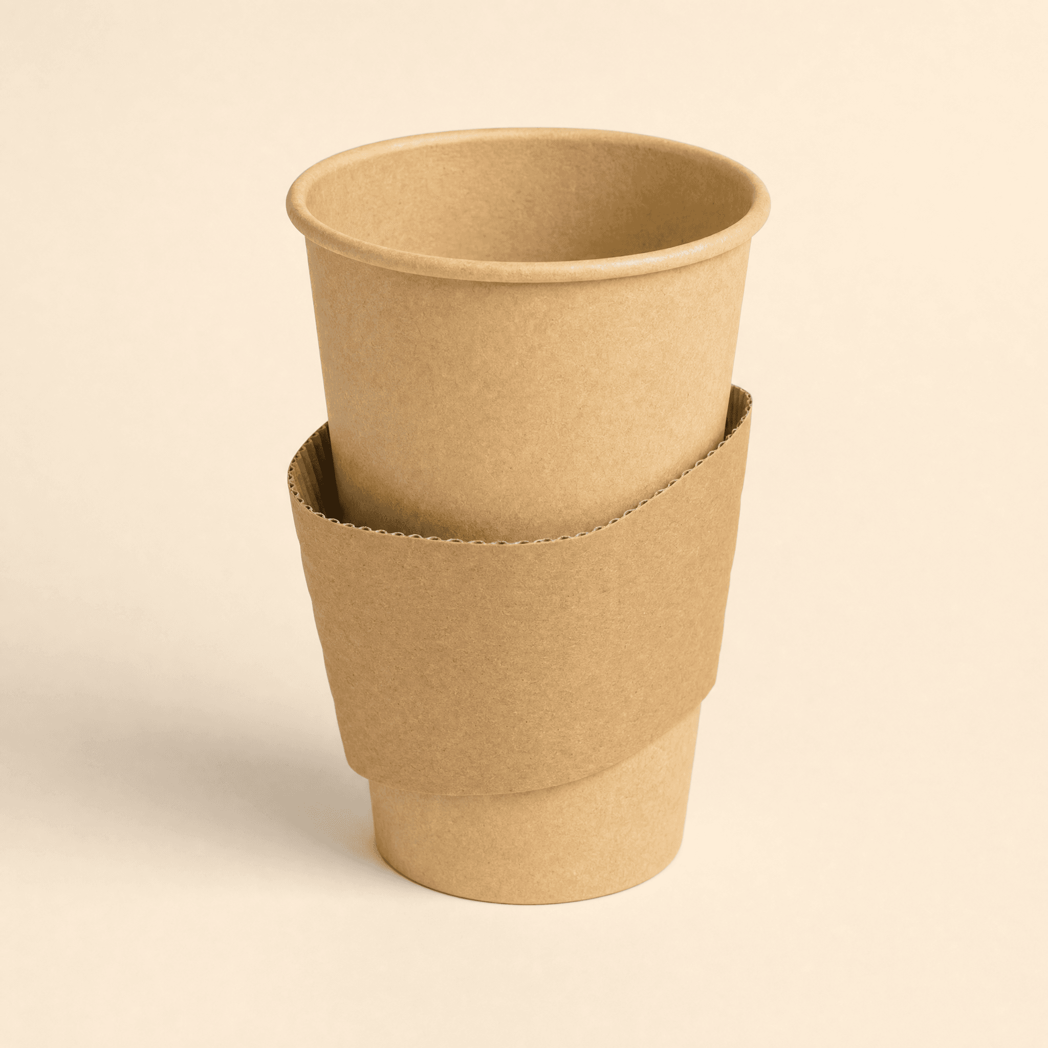 Corrugated kraft sleeve fitted around the middle of a kraft hot cup on a cream background