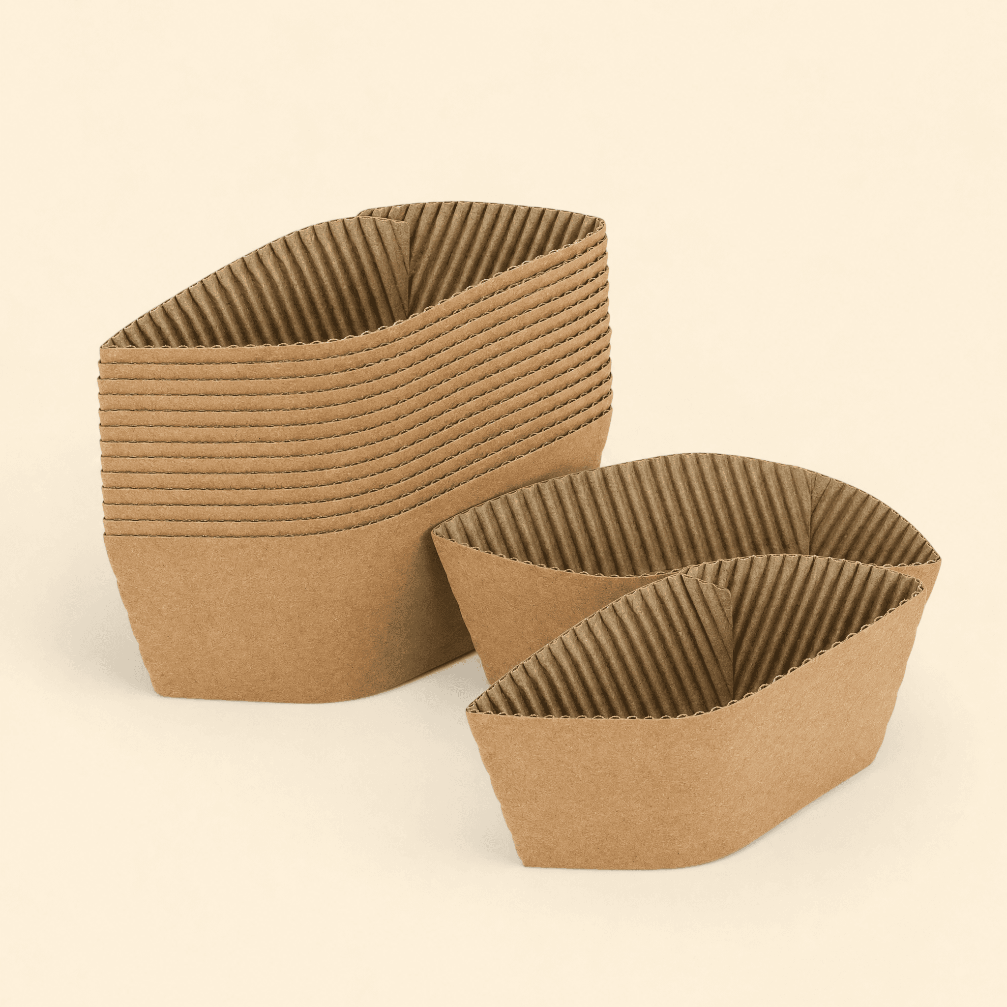 A stack of corrugated kraft coffee cup sleeves nested together, showing they are sold in bulk by the case