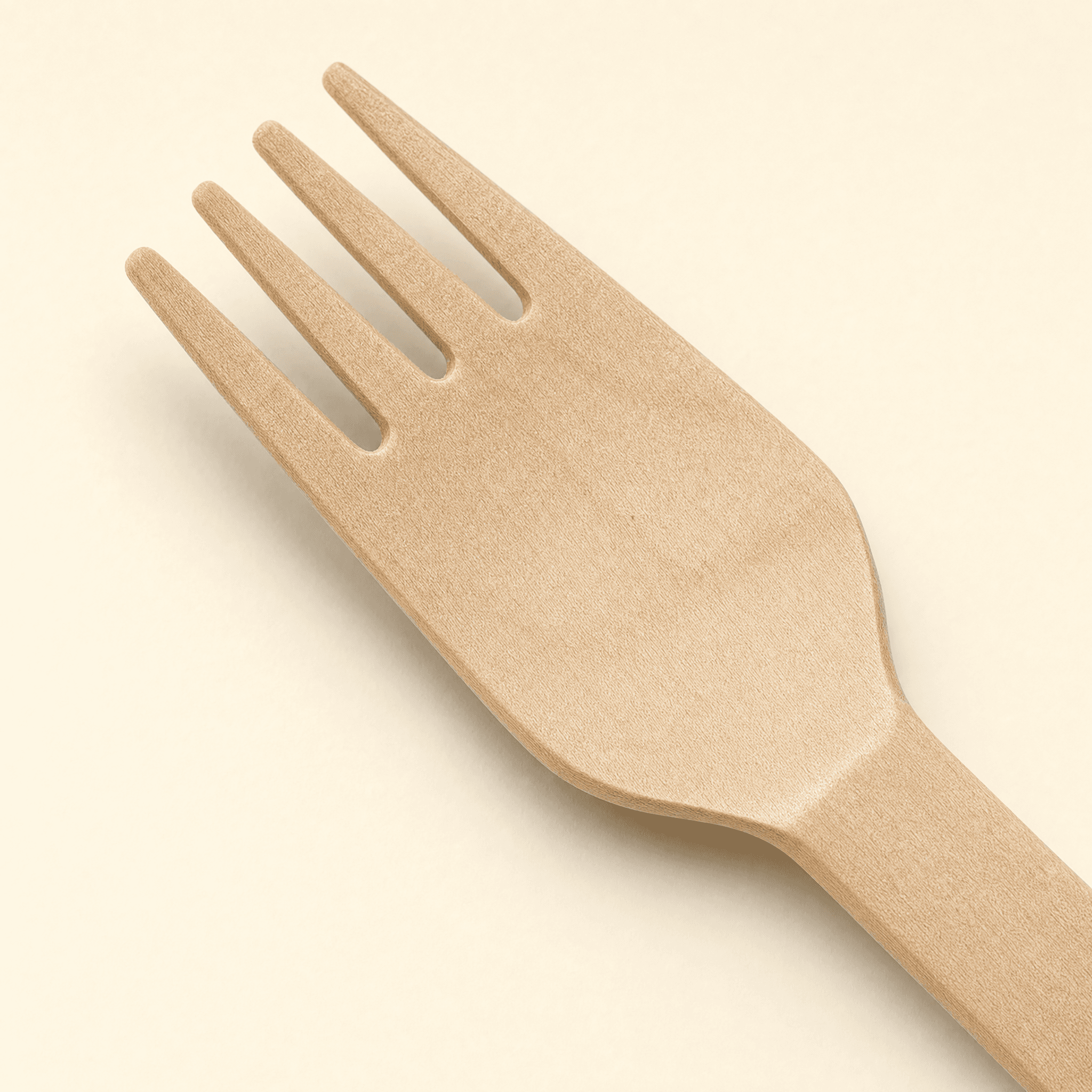 Close-up of the fork head showing the four tines, the deep slots between them and the natural birch wood grain