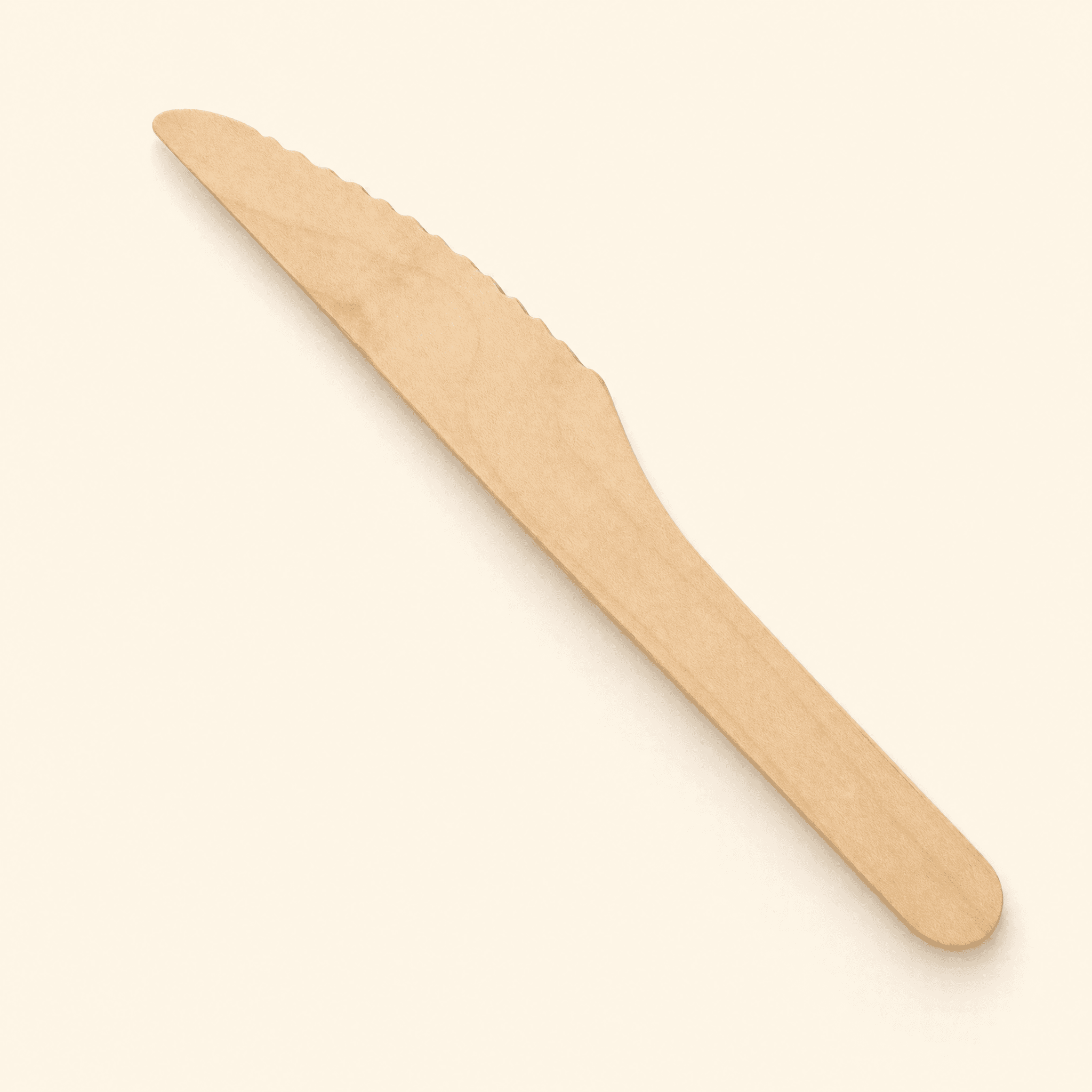 Single birch wood knife at a three-quarter angle on a cream studio background, showing the serrated cutting edge and flat rounded handle