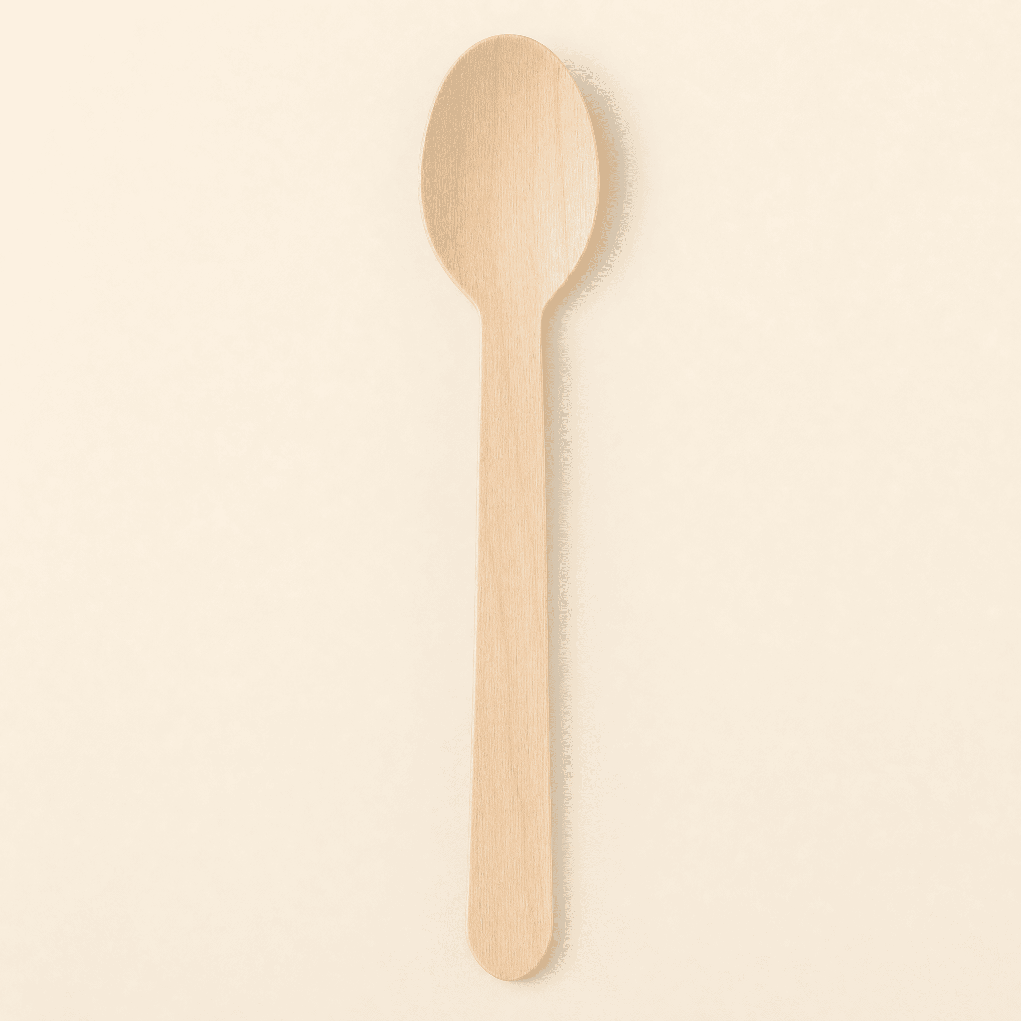 Top-down view of the birch spoon on a cream background, showing the deep oval bowl